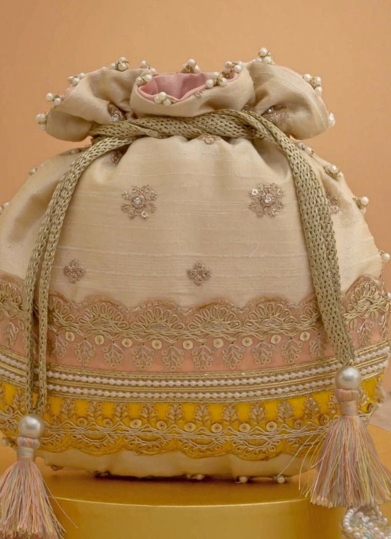 Amyra Beige Silk Potli With Pink And Yellow WorkShop Jashn